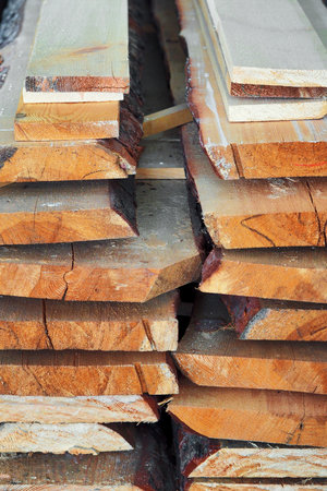 New planed wooden boards stacked in sawmill. Procurement and sale of building material. Dry wood. Woodworking. Background.の写真素材