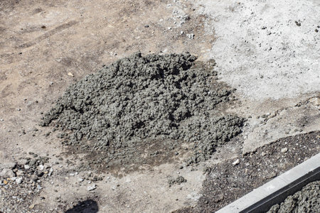 Road and sidewalk are full of holes. Road surface repair. Eliminate bumps and holes in road. Background. Top view of surrounding area.の写真素材