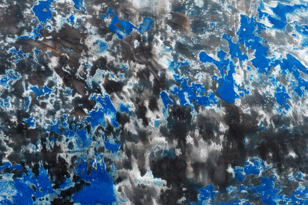 Abstract texture background. Sanded brushed metal surface with blue paint. Empty butt.の写真素材