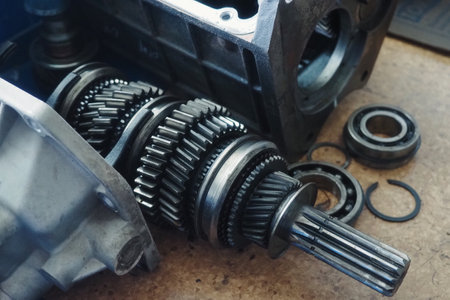 Gear spare part for car lies on workbench. Gears and transfer case. equipment repair.の写真素材