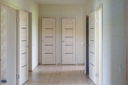 Corridor with room doors. Empty apartment. Finishing and renovation of premises. View.の写真素材