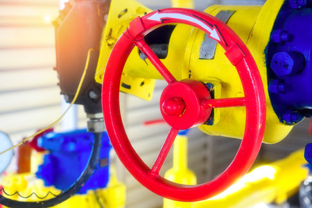 Industrial background. The gas pipeline is yellow with additional equipment, pipes and a valve for shutting off the gas supply.の写真素材