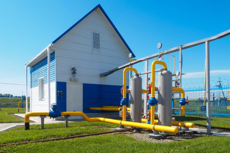 View of territory of gas distribution station from outside on sunny summer day. Industrial building. New gas supply facilities. Transportation of natural gas through pipes.の写真素材
