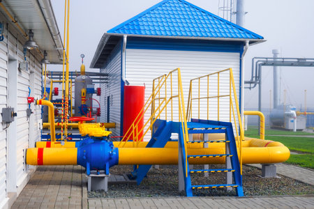 Gas distribution station. View of territory of gas distribution station with pipes and containers. Industrial facility of Gazprom company. Transportation of natural gas through pipes. Background.の写真素材