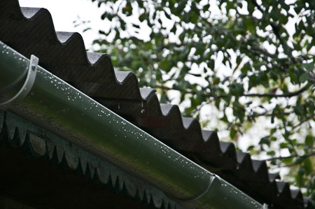 drops fall from the roof to the drain trough during rain