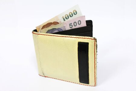 Yellow leather wallet with money isolated on white backgroundの写真素材