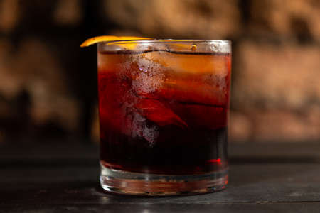 Cocktail Negroni on a wooden board. Negroni cocktail at the bar. Selective focus