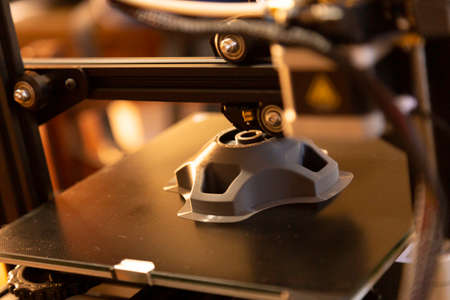 3D printer prints a prototype piece. Selective Focus.