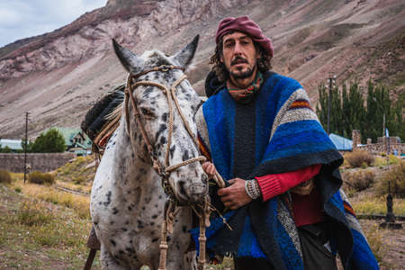 Mendoza, Argentina, March 16, 2021: Argentine Gaucho with his horses
