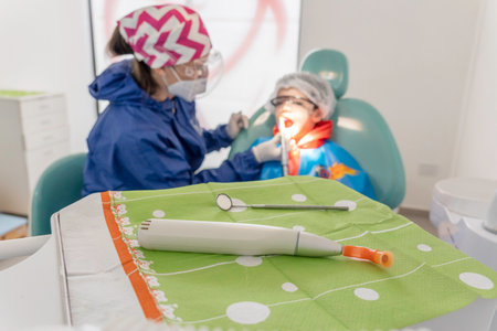 UV light in dentist office and a child being check his mouth. Selective Focus.の写真素材