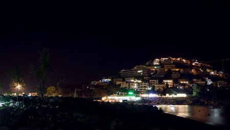 Beautiful night view at village by the seaの写真素材