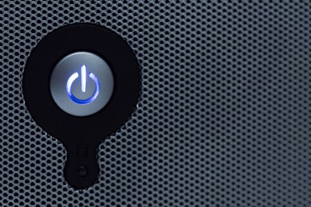 Power button in perforated panel copy space on the rightの写真素材