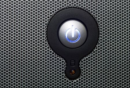 Power button in perforated panel copy space on the leftの写真素材