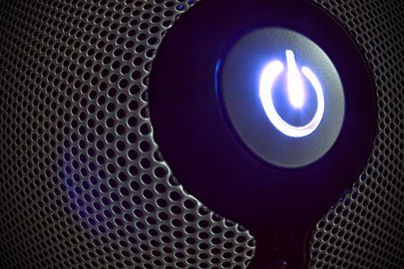 Power button in perforated panel fish eye effectの写真素材