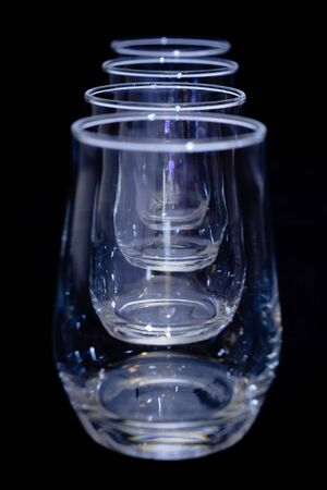 four empty glasses on blackの写真素材