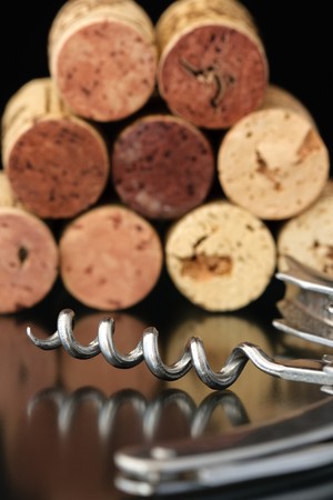 Corkscrew with corks on backgroundの写真素材