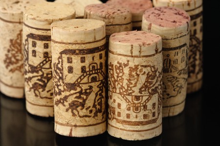 Wine corks on reflecting black backgroundの写真素材