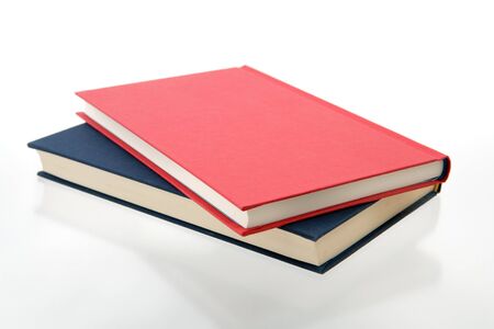 closed red and blue books on a reflecting white backgroundの写真素材