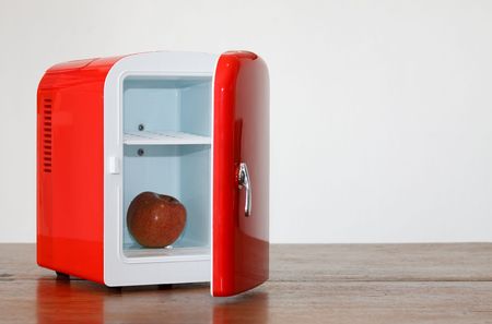 Shiny bright red miniature fridgeの写真素材