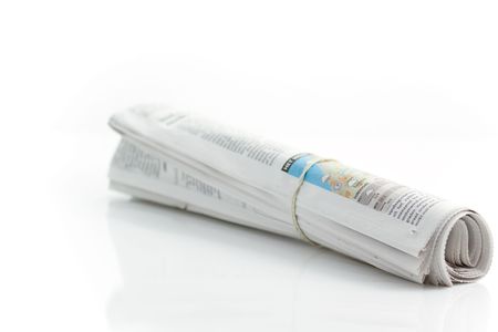 Rolled up newspaper with rubber bandの写真素材