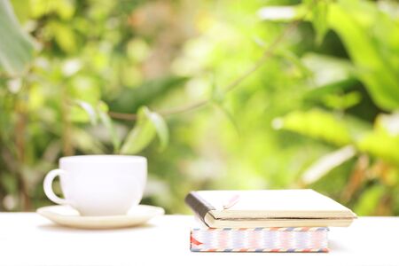 Notebook  and coffee on wooden tableの写真素材