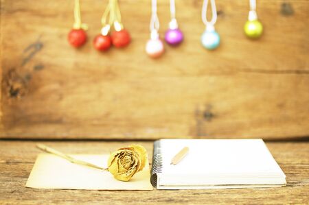 papers box on wood table and old roseの写真素材