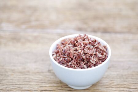 Organic brown rice on wooden tableの写真素材