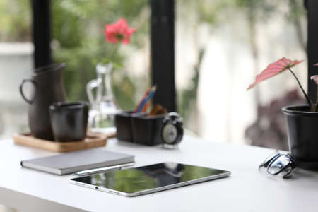 Work stationary with tablet notebook clock and plants