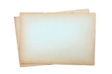 Isolated old brown worn out ripped yellow background paper stacks textureの写真素材