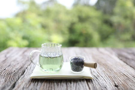 lavender tea in glass pot on wooden tableの写真素材