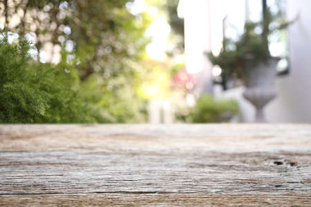 Wooden table surface view with blur garden backgroundの写真素材