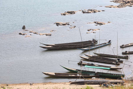 Small fishing boats resting in riverの写真素材