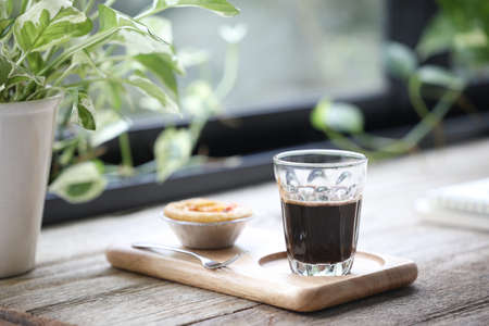 Coffee glass cup and Egg tart dessert on wooden tray