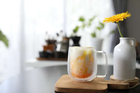 Passion fruit in glass cup and a vase of Yellow gerberaの写真素材