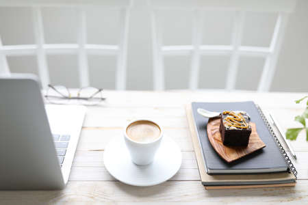 Coffee and almond brownie and laptopの写真素材