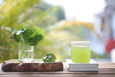 pennywort juice and notebook on wooden tableの写真素材