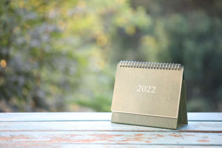 Green calendar on blue wooden tableの写真素材