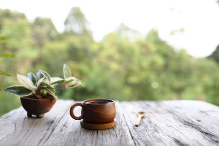 Wooden coffee cup and hoya tree plantの写真素材