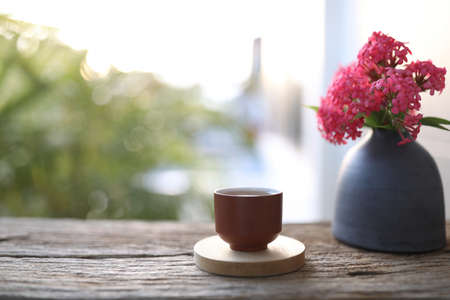 earthenware tea cup and vase of Panama Roseの写真素材