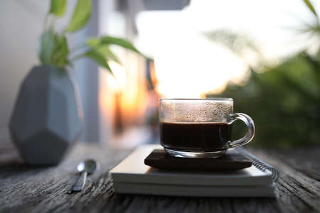 americano coffee glass cup and notebooksの写真素材