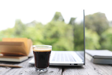 coffee glass cup and laptop on glass table outdoor view