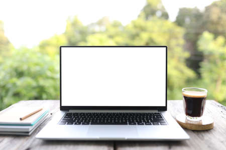 Laptop with white screen and coffee glass cup with crema