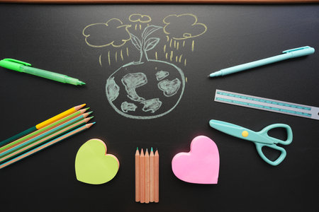 earth doodle with stationery on black chalkboardの写真素材