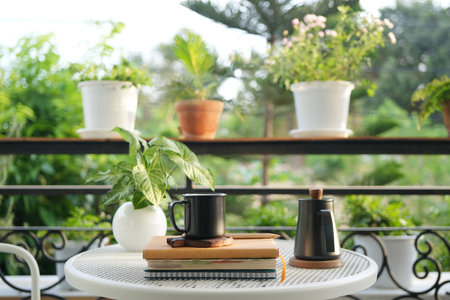 black tea pot and tea mug on metal table at balcony outdoorの写真素材