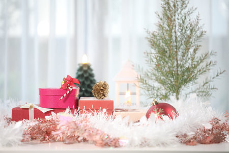 Christmas gift box with ornament and decoration on white table with small pine treeの写真素材