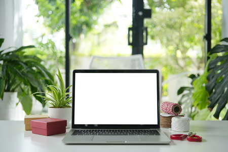 Laptop with gift box and scissors, minimal interiorの写真素材