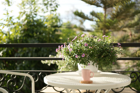 Pink ceramic coffee cup on white metal table vintage outdoorの写真素材