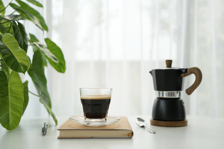 coffee cup and black moka pot by the window, minimal homeの写真素材