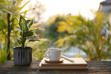 White coffee cup and notebook, outdoor cozy working spaceの写真素材