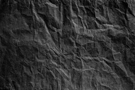 Black crumpled paper material textureの写真素材